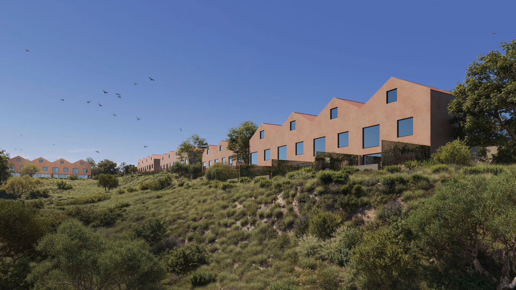 A row of Casa Miradouro townhouses with tall gables stepping along a green hillside